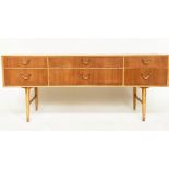 LOW CHEST BY MEREDEW, 1960s oak and walnut, with six short drawers and tapering supports, 168cm W
