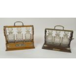 TANTALUSES , two, one Victorian oak, with silver plated mounts and three cut glass decanters