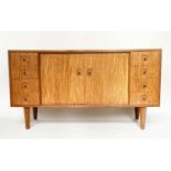 FREDERICK RESTALL SIDEBOARD, 1960s teak of bowed outline with two doors flanked on each side by four