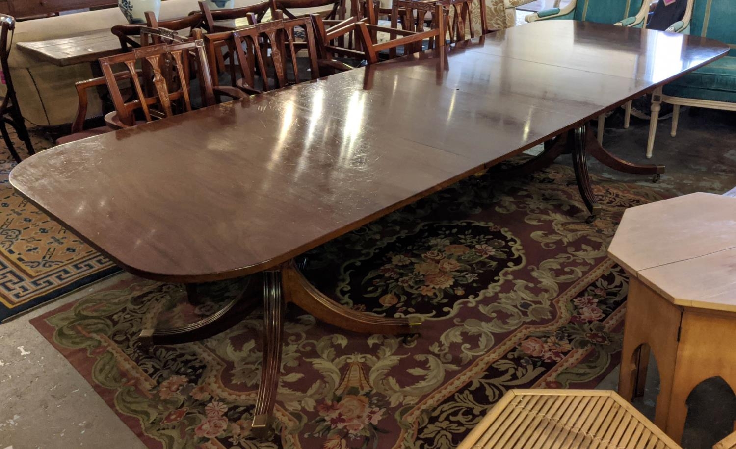 WILLIAM TILLMAN EXTENDABLE DINING TABLE, Georgian style mahogany with two leaves, double pedestal,