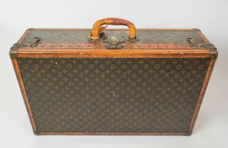 LOUIS VUITTON SUITCASE, early 20th century leather trim and brass handware, 77cm L x 47cm W x 22cm