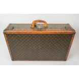 LOUIS VUITTON SUITCASE, early 20th century leather trim and brass handware, 77cm L x 47cm W x 22cm