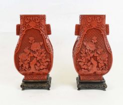 VASES, a pair, Chinese Cinnebar style Hu form on carved wooden stands, 35cm H. (2)