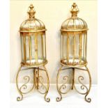 STORM LANTERNS ON STANDS, gilt metal, Regency style, 115cm x34cm x34cm.