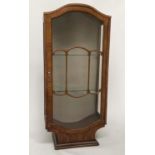 ART DECO DISPLAY CABINET, burr walnut with two 'cloud' shaped glazed doors and shaped plinth, 57cm W