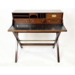 CAMPAIGN STYLE DESK, tooled leather with an arrangement of drawers and pigeon holes on trestle base,