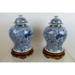 BALUSTER VASES, a pair, Chinese blue and white decorated with floral ground and phoenix on carved