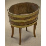 JARDINIERE, 58cm H x 55cm x 43cm, George III oak and brass banded on later legs.