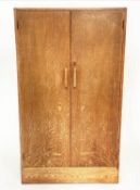 WARDROBE, 1950s oak in the manner of Heals of London with two doors enclosing hanging space and