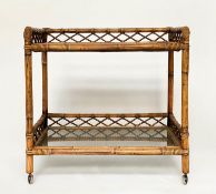 CONSOLE TABLE, rattan framed and cane panelled with two glazed shelves, gallery and castors, 72cm