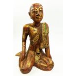 FIGURE OF A THAI MONK, in sitting position, wooden with parcel gilt decoration, applied stones to