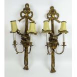 WALL LIGHTS, a pair, 19th century carved giltwood with bow ribbon tops above eagles and twin