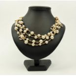 CHANEL NECKLACE, gilt metal and faux pearl set double strand necklace, bearing the Chanel logos