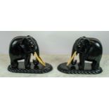 ELEPHANTS, a pair, Anglo-Indian circa 1880 carved ebony, 18cm H x 25cm. (2)