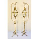 Lanterns on stands, 163cm high, 35cm across, Regency style, gilt metal frames, cross-sectioned