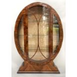 ART DECO DISPLAY CABINET, 144cm H x 97cm W x 32cm D, figured walnut, of oval form, with glazed