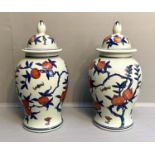 VASES AND COVERS, a pair, 42cm H, glazed ceramic with fruit tree print design.