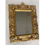 WALL MIRROR, Florentine style carved giltwood with scrolling foliate frame, 86cm W x 115cm H.