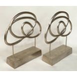 SCULPTURES, a pair, silvered metal on stands, 76cm H x 70cm W. (2)