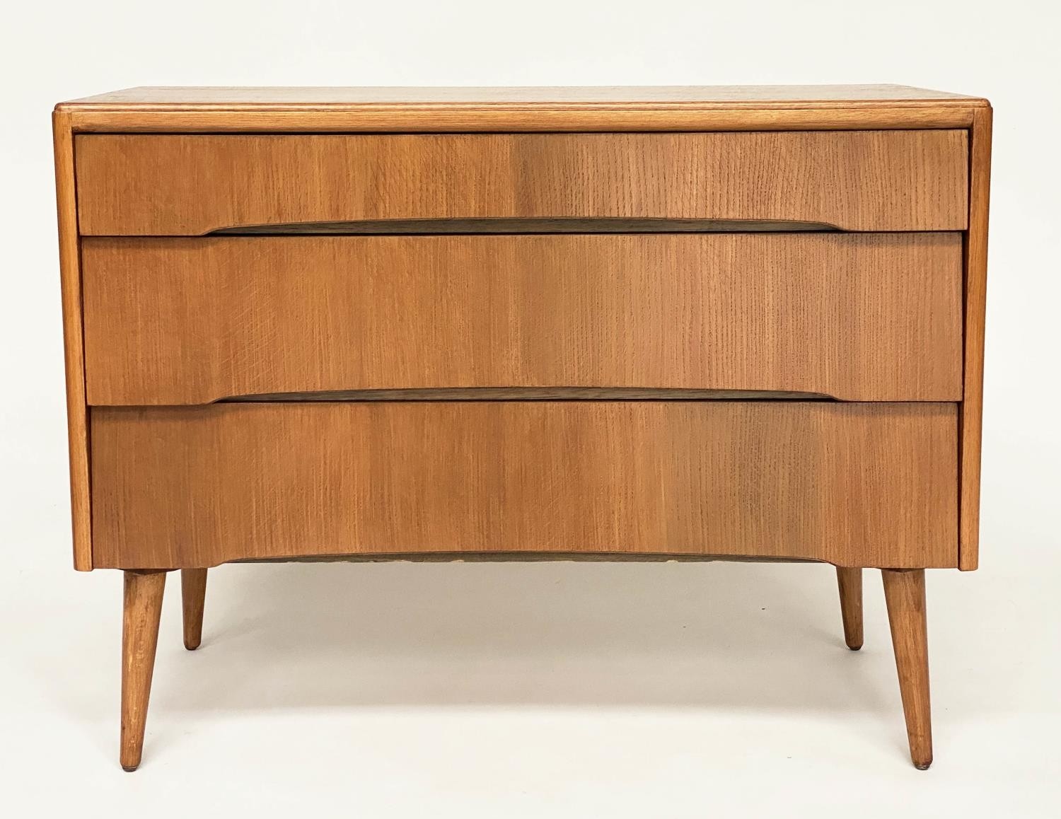 AVALON YATTON CHEST, 1970s oak, with three long drawers and splay supports, 91cm W x 42cm D x 70cm.