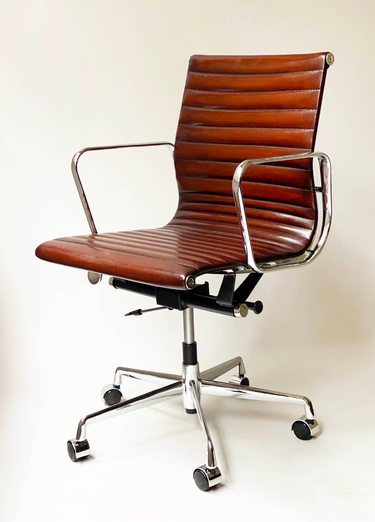 REVOLVING DESK CHAIR, Charles and Ray Eames inspired with ribbed mid brown tan leather seat