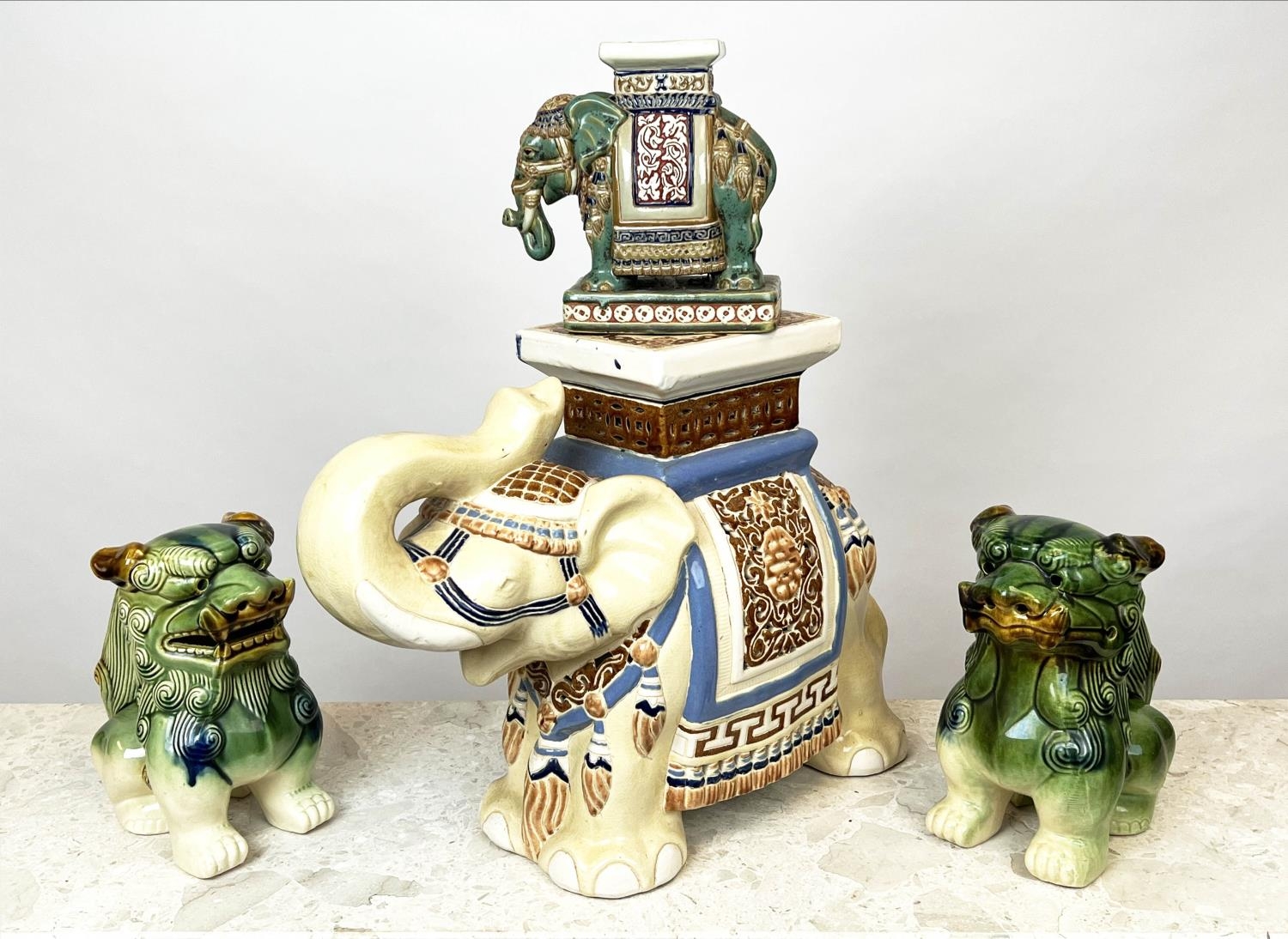 ASIAN CERAMICS, to include two elephant stands and a pair of dogs of foo, largest 39cm H x 50cm. (4)