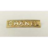 A CHANEL GILT METAL BAR BROOCH, embossed with 'Chanel', logo to back.