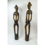 SENOUFO RHYTHM POUNDER FIGURES, a pair, Ivory Coast. (2) 132cm H