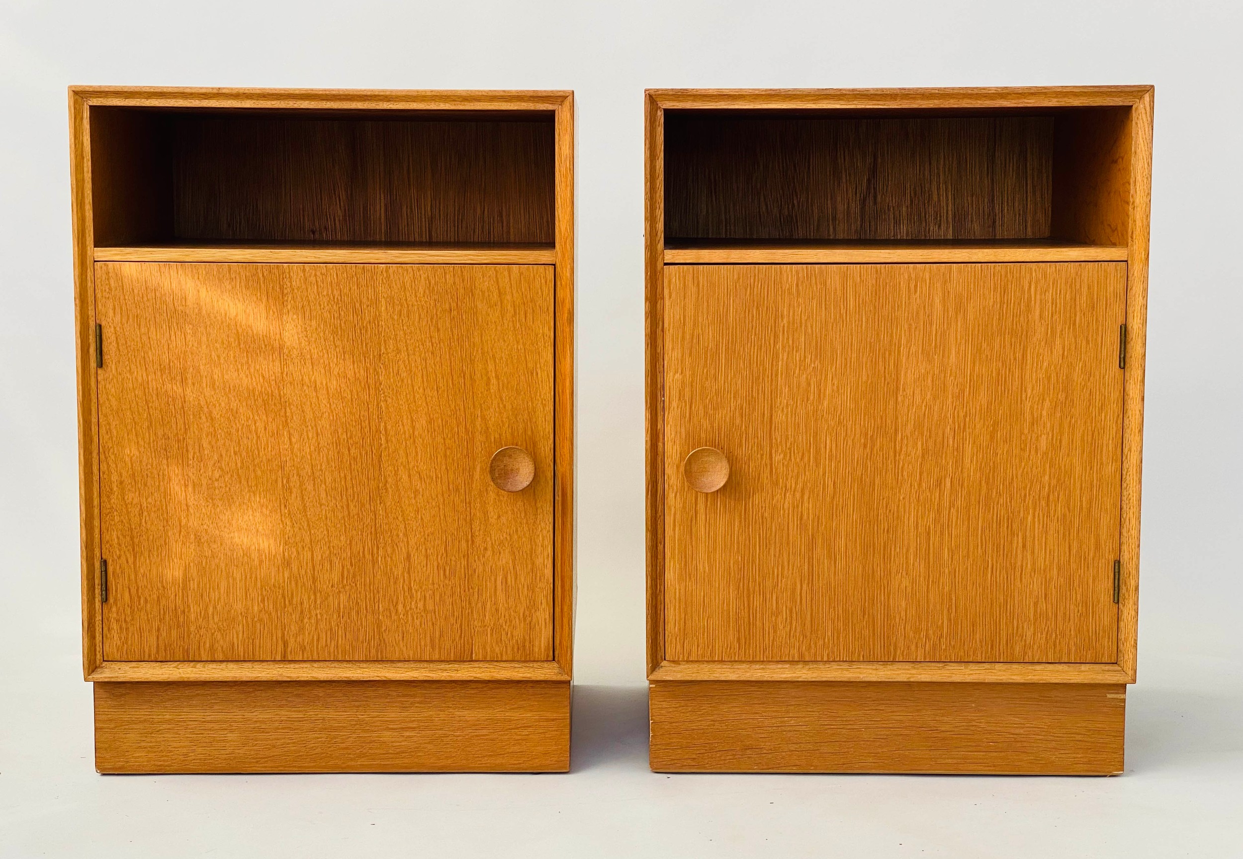 MEREDEW CABINETS, a pair, 1960s oak each with panelled door enclosing shelf, 46cm W x 36cm x 65cm H.