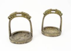 CHINESE BRONZE STIRRUPS, a pair, with cast dragon heads, 15cm H x 13cm W.