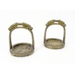 CHINESE BRONZE STIRRUPS, a pair, with cast dragon heads, 15cm H x 13cm W.