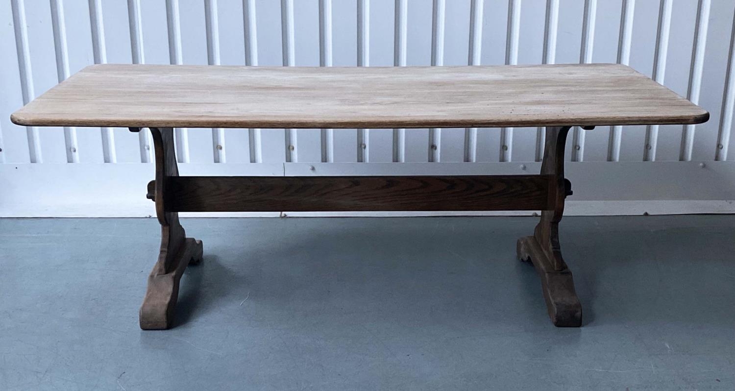 REFECTORY DINING TABLE, round rectangular oak, planked and raised upon shaped trestle supports