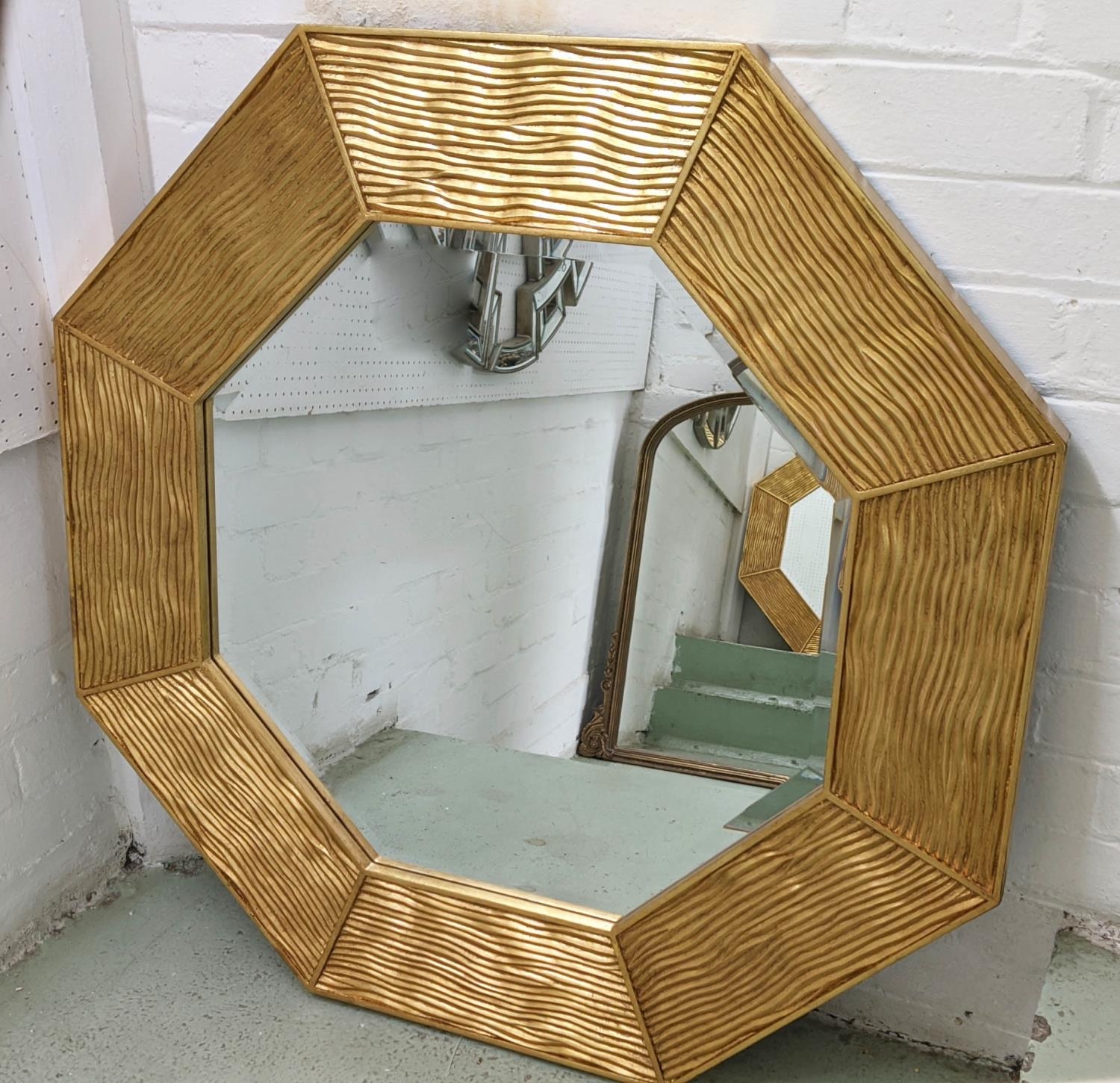 WALL MIRROR, furwood design, octagonal form, gilt rusticated finish, bevelled edge glass, 90cm D.