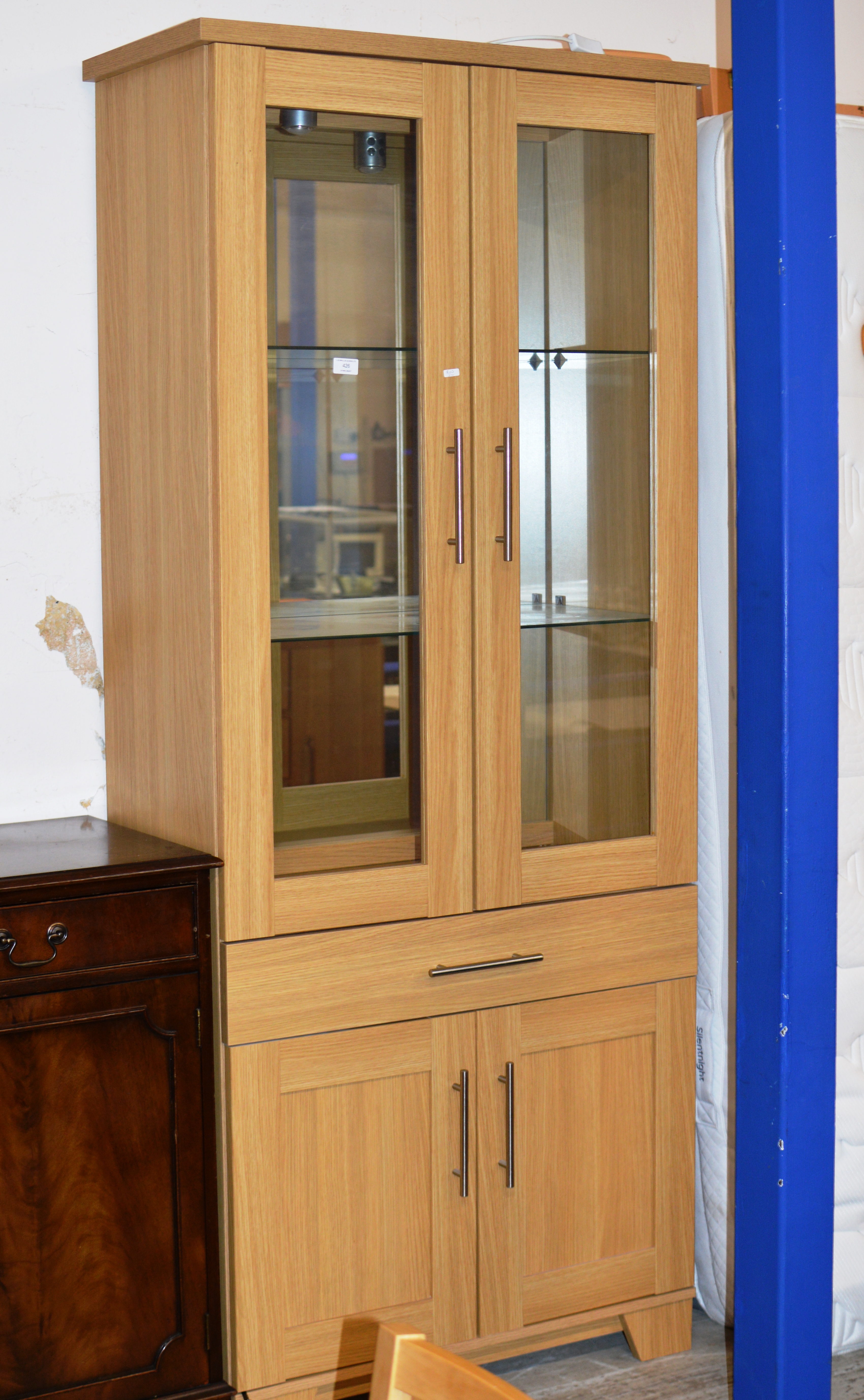 MODERN OAK FINISHED DOUBLE DOOR DISPLAY CABINET WITH UNDER DRAWER & PRESS