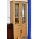 MODERN OAK FINISHED DOUBLE DOOR DISPLAY CABINET WITH UNDER DRAWER & PRESS