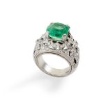 A emerald and diamond cluster ring