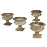 SET OF FOUR COMPOSITION STONE URNS MODERN