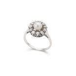 A pearl and diamond cluster ring