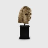 SUMERIAN HEAD OF A FEMALE WORSHIPPER SUMERIA, EARLY DYNASTIC PERIOD, 2600 - 2350 B.C.