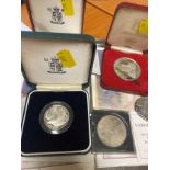 Seven limited edition silver proof coins with documents.