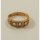 An Edwardian three stone diamond and pearl ring set in 18 carat gold