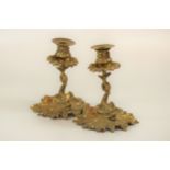 A pair of brass dolphin-stem candlesticks , 19cm high (2)