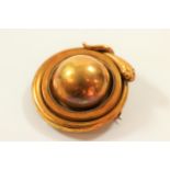 A Victorian gold coloured metal brooch in the form of a coiled snake, in original fitted case