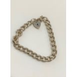 A silver bracelet with heart padlock