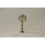 An 18th century Silver Coloured metal Pipe tamper. Apparently unmarked. Set with a Queen Anne