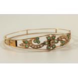 An 18 carat gold emerald, seed pearl and possibly white sapphire bangle (lots of damaged/broken