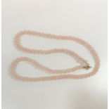 A rose quartz bead necklace