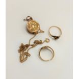 A collection of 9 carat gold items - a pomander/pendant, two scrap rings and curb neck chain