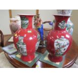 A Pair of Chinese Vases. 20th century. Each decorated with vases on a red ground. Six character mark