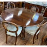 A mahogany Circular Dining table. Early 20th century. Together with four Victorian Balloon Back